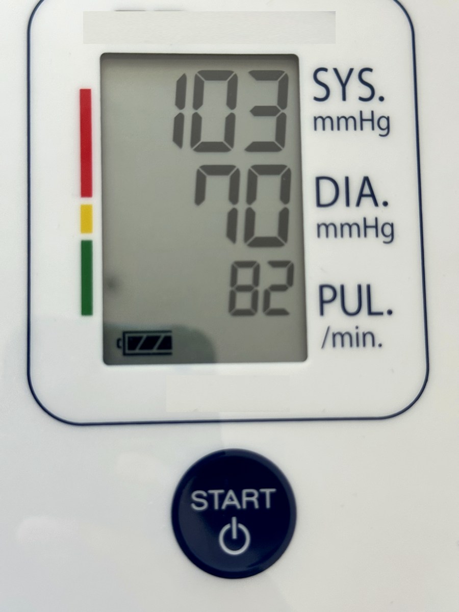 A home blood-pressure monitor reading 103 over 70, pulse 82